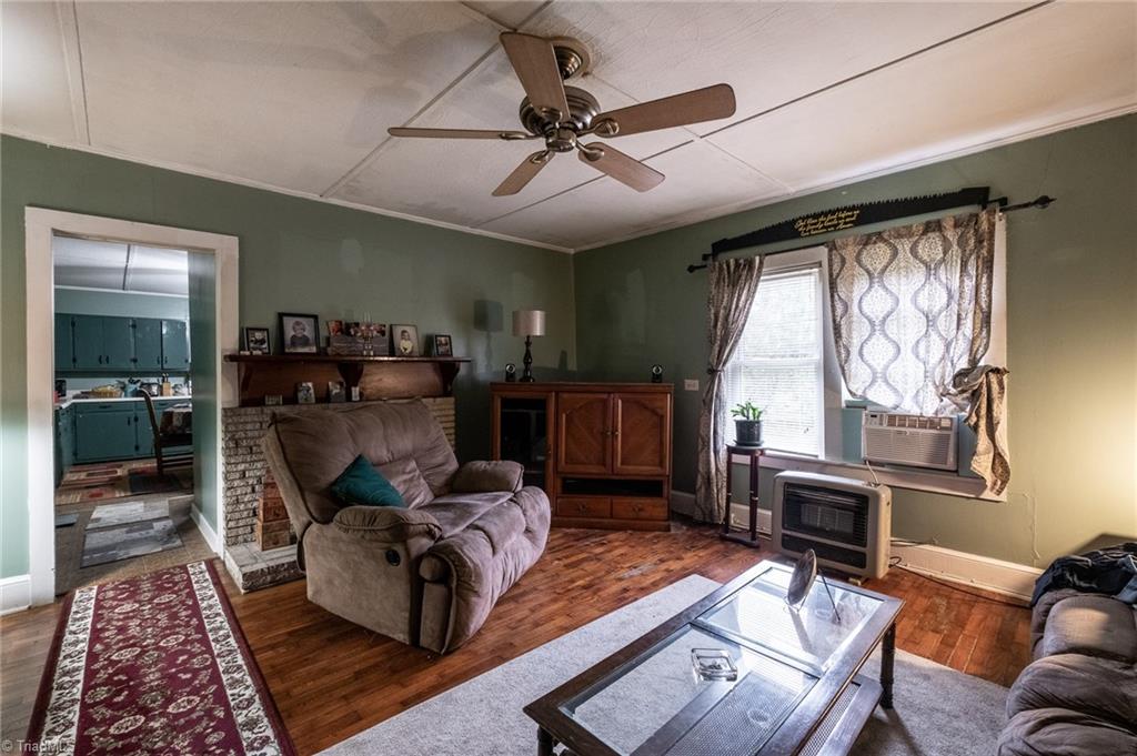 1180 Couchs Fish Lake Road State Road, NC 28676 - Photo 22 of 31 Den with hardwood floors and fireplace.