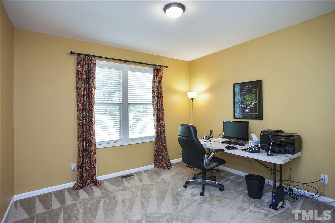 8621 Benzinger Drive Raleigh, NC 27613 - Photo 11 of 25 a view of a workspace with furniture and a window