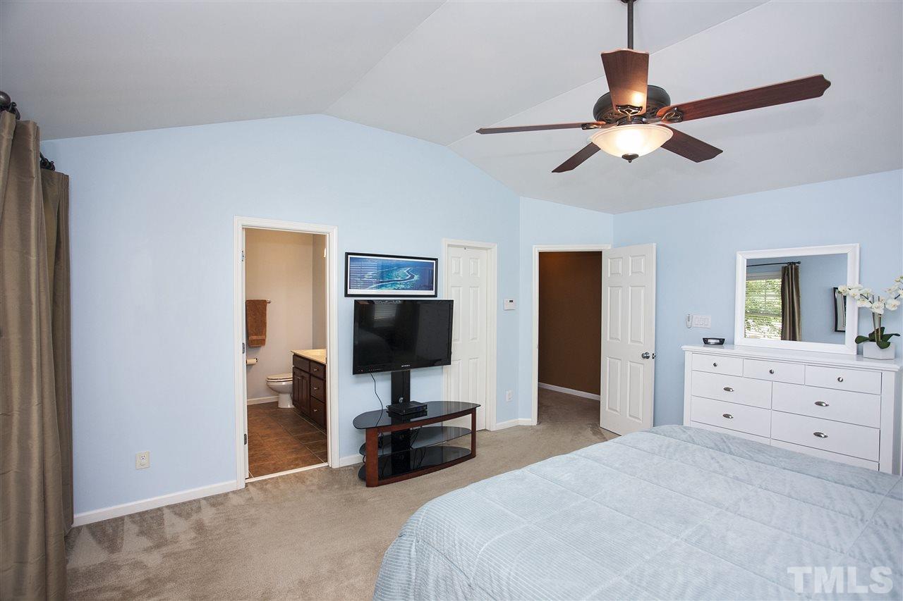 8621 Benzinger Drive Raleigh, NC 27613 - Photo 14 of 25 a bedroom with a bed and a flat screen tv