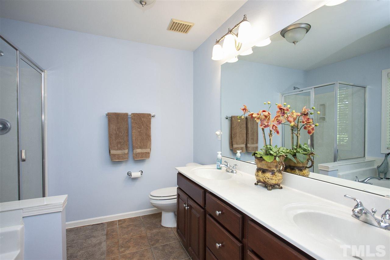 8621 Benzinger Drive Raleigh, NC 27613 - Photo 15 of 25 a bathroom with a double vanity sink mirror and toilet