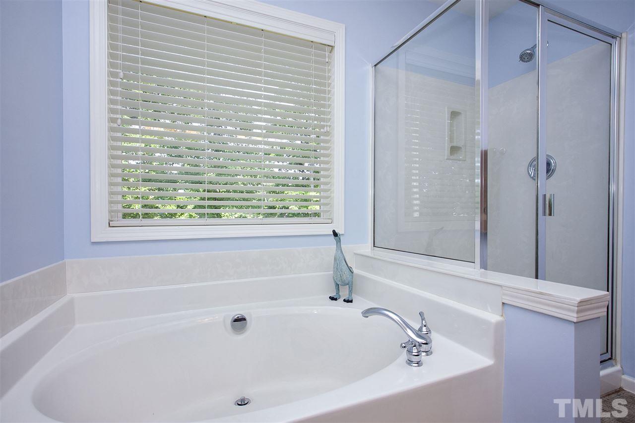 8621 Benzinger Drive Raleigh, NC 27613 - Photo 16 of 25 a bathroom with a bathtub and shower