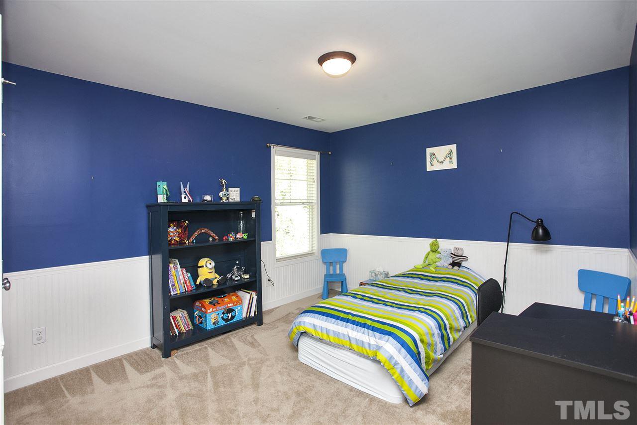 8621 Benzinger Drive Raleigh, NC 27613 - Photo 18 of 25 a bedroom with a bed and a couch