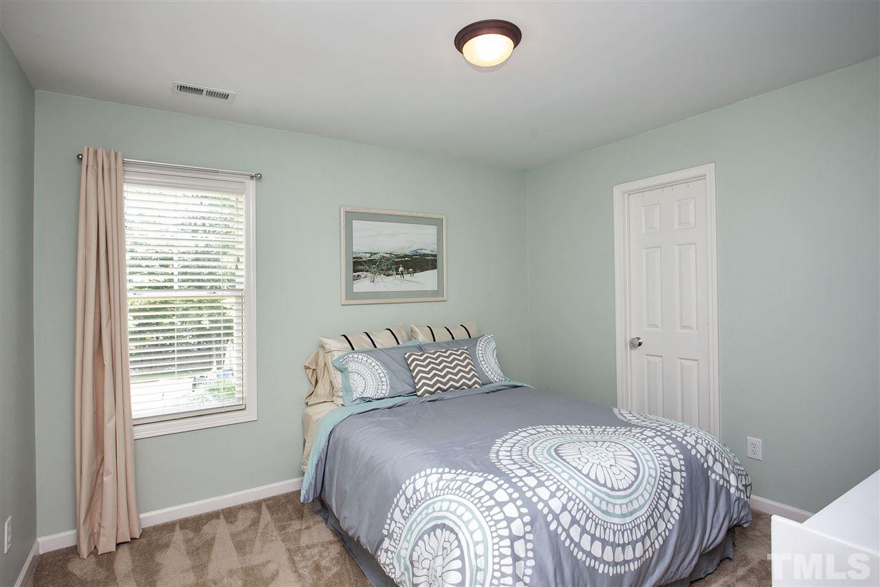 8621 Benzinger Drive Raleigh, NC 27613 - Photo 19 of 25 a bedroom with a bed and a window