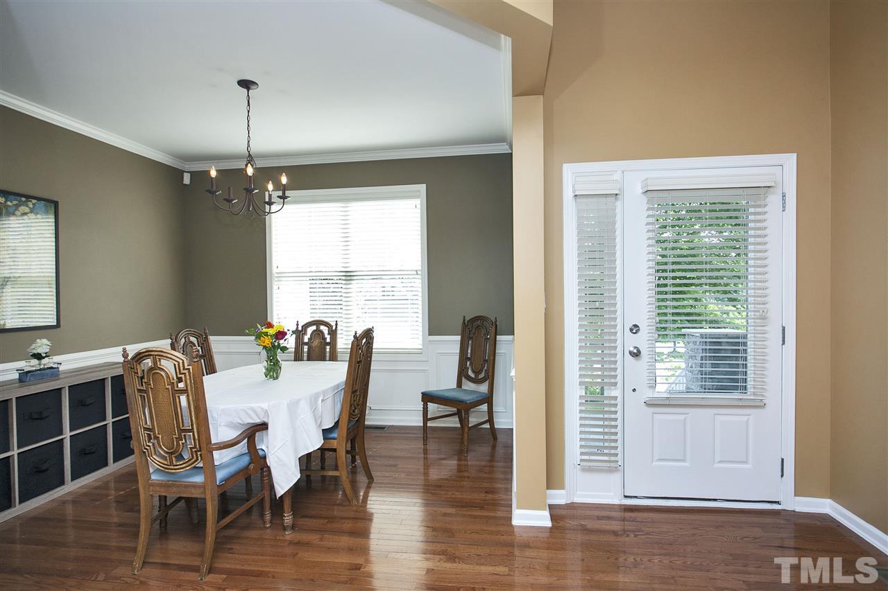 8621 Benzinger Drive Raleigh, NC 27613 - Photo 3 of 25 a view of a dining room with furniture window and wooden floor