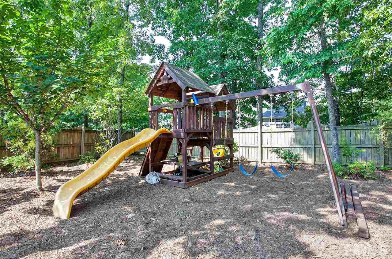 8621 Benzinger Drive Raleigh, NC 27613 - Photo 23 of 25 a view of a house with a park