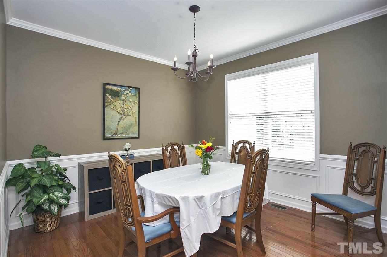 8621 Benzinger Drive Raleigh, NC 27613 - Photo 4 of 25 a view of a dining room with furniture window and wooden floor