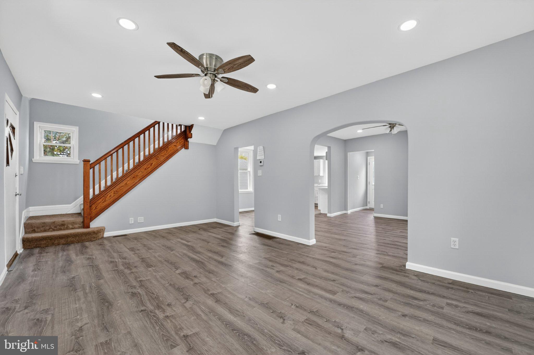 5312 Catalpha Road Baltimore, MD 21214 - Photo 45 of 59 a view of an empty room with wooden floor and a ceiling fan