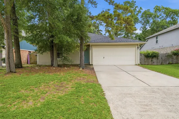 a front view of house with yard and trees