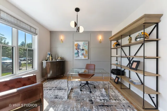 a living room with furniture a rug and a chandelier
