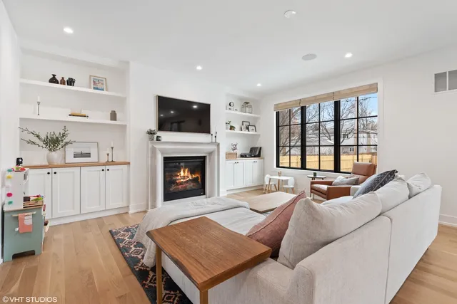 a living room with furniture fireplace and flat screen tv