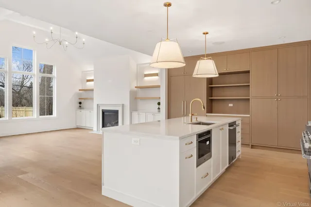 a kitchen with a stove and a chandelier