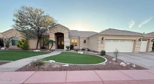 a view of a house with a swimming pool and a yard