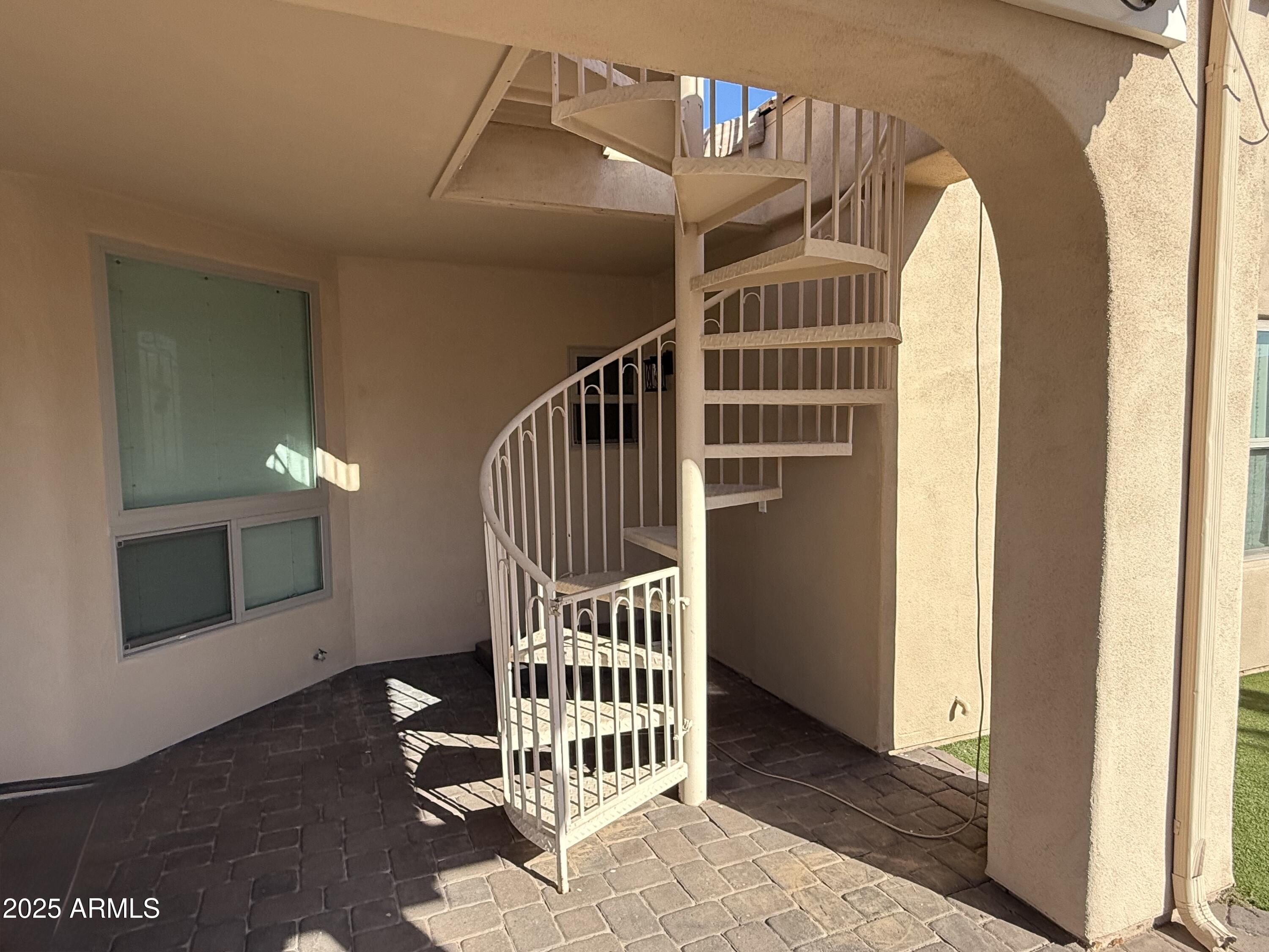 4055 North Recker Road, Unit 62 Mesa, AZ 85215 - Photo 15 of 47 a view of staircase with white walls and a window