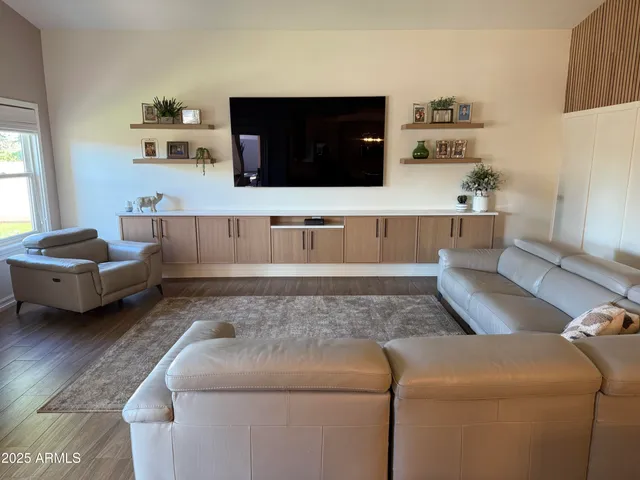 a living room with furniture flat screen tv and a fireplace