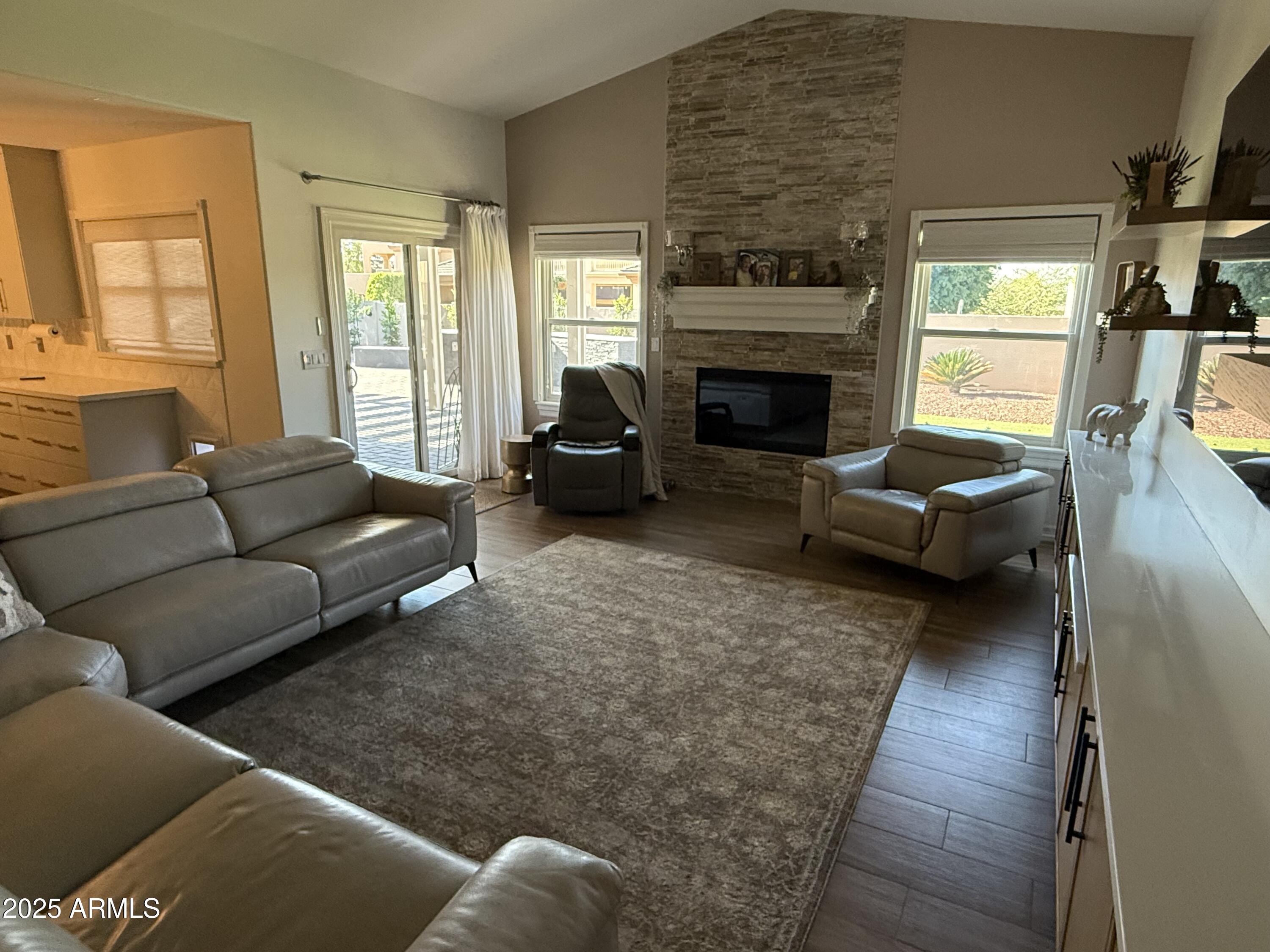 4055 North Recker Road, Unit 62 Mesa, AZ 85215 - Photo 24 of 47 a living room with furniture and a fireplace