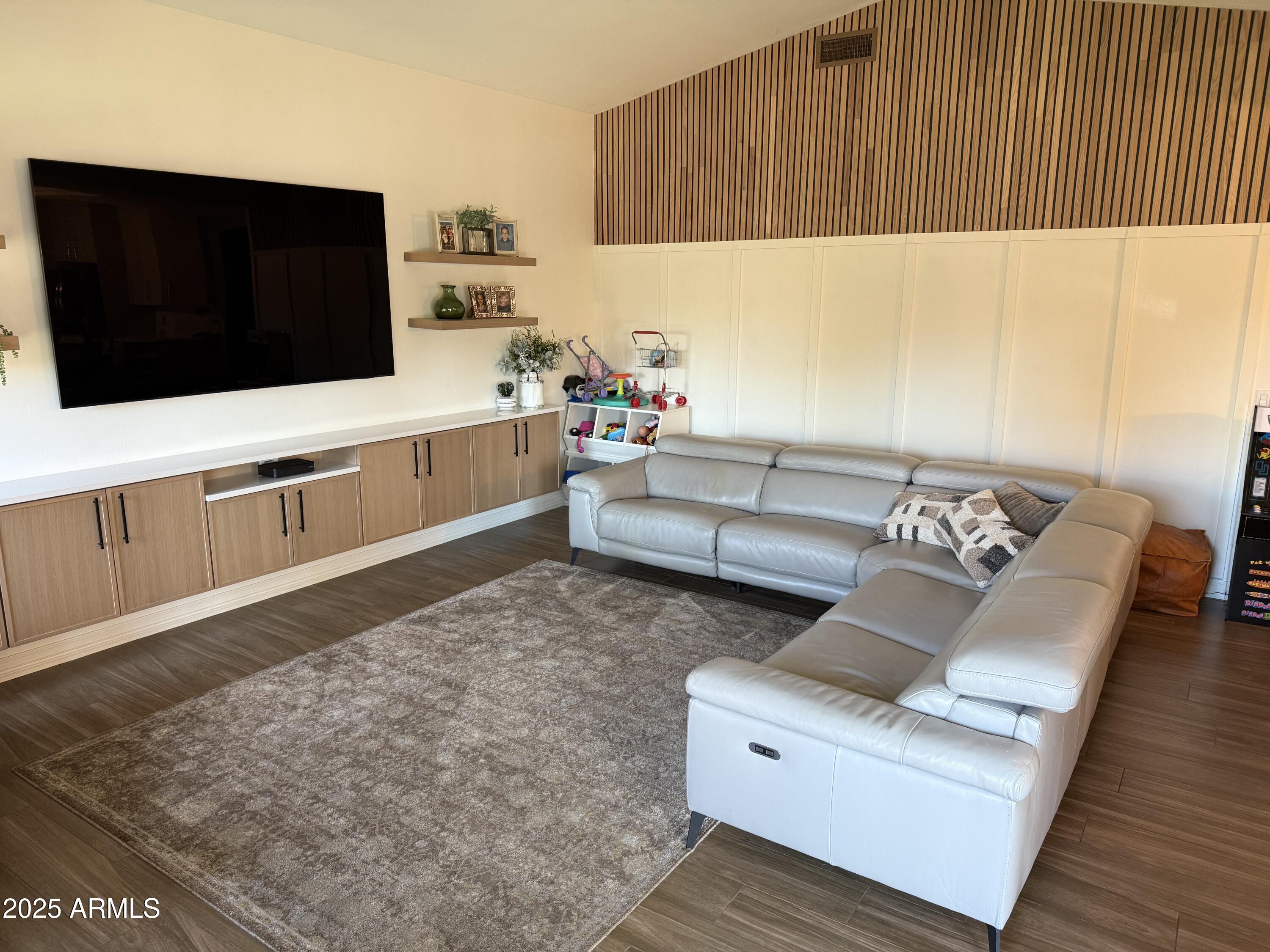 4055 North Recker Road, Unit 62 Mesa, AZ 85215 - Photo 26 of 47 a living room with furniture and a flat screen tv