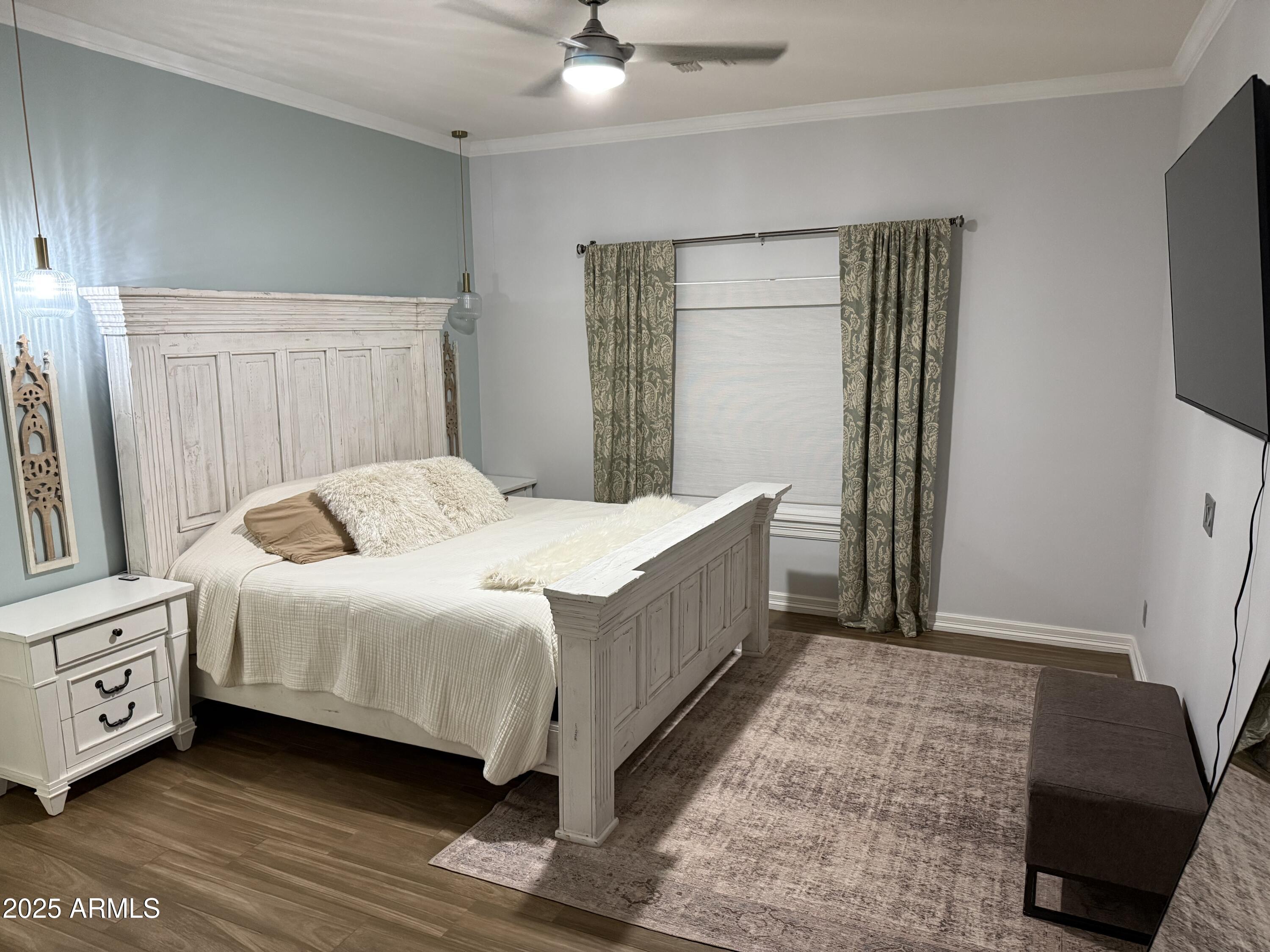 4055 North Recker Road, Unit 62 Mesa, AZ 85215 - Photo 29 of 47 a bedroom with a bed and a mirror on dresser