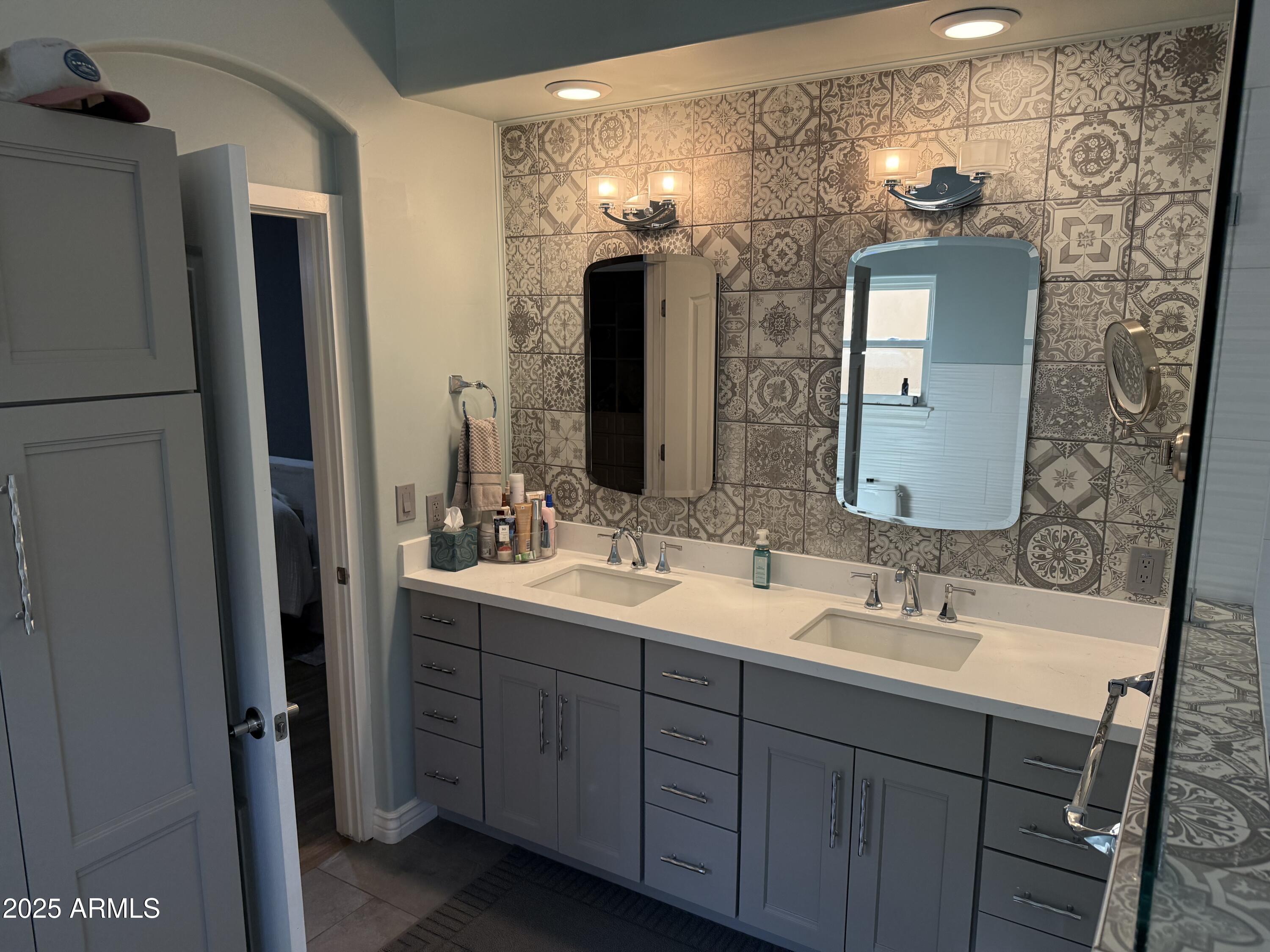 4055 North Recker Road, Unit 62 Mesa, AZ 85215 - Photo 31 of 47 a bathroom with a double vanity sink and a mirror