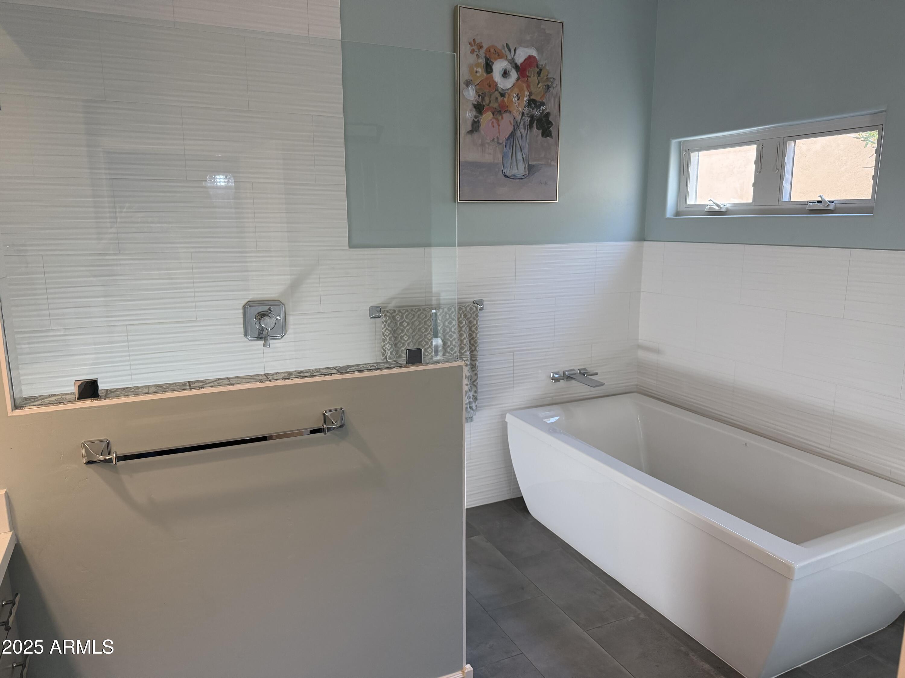 4055 North Recker Road, Unit 62 Mesa, AZ 85215 - Photo 34 of 47 a bathroom with a bathtub and sink