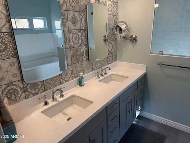 a bedroom with a bed and a flat tv screen on dresser