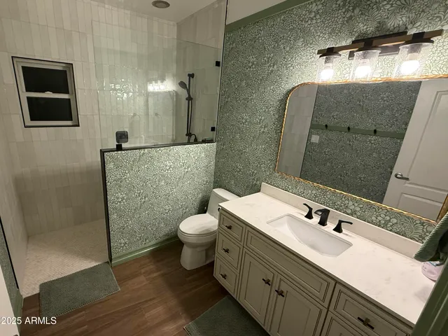 a bathroom with a toilet and a shower