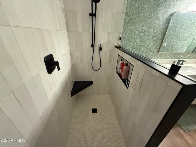 a bed sitting in a bedroom next to a bathroom