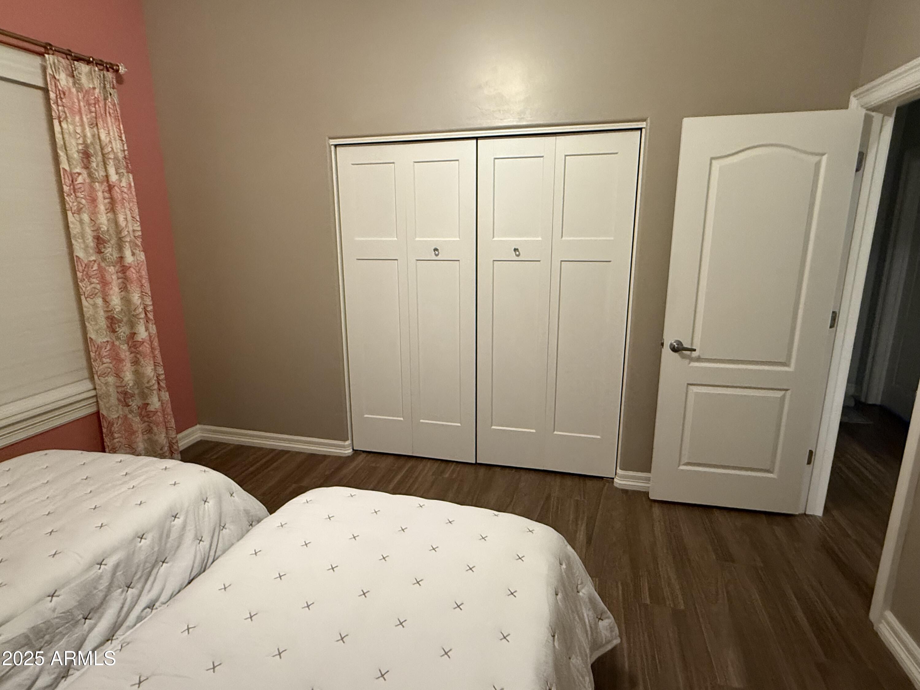 4055 North Recker Road, Unit 62 Mesa, AZ 85215 - Photo 42 of 47 a bedroom with a bed and a wooden floor