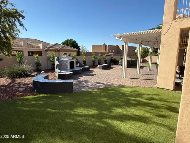 a view of a patio with table and chairs and potted plants