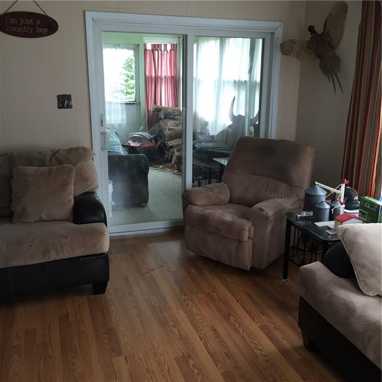 289 Golf Course Road Volant, PA 16156 - Photo 8 of 24 Living Room looking into enclosed sunporch.