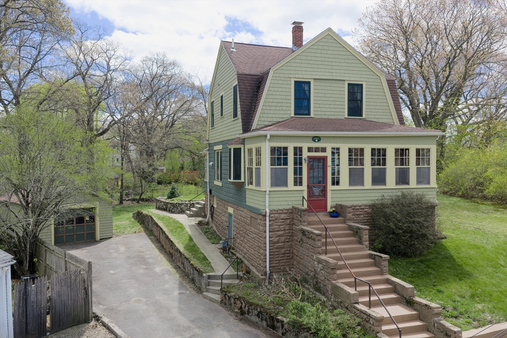 54 Oak Street Dedham, MA 02026 - Photo 1 of 36 a front view of a house with a yard