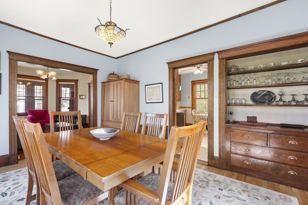 54 Oak Street Dedham, MA 02026 - Photo 13 of 36 a dining room with furniture a rug a potted plant and a chandelier