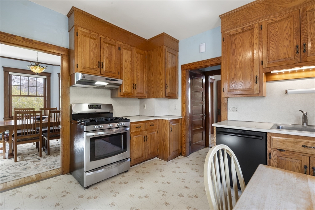54 Oak Street Dedham, MA 02026 - Photo 14 of 36 a kitchen with stainless steel appliances granite countertop a stove refrigerator sink and cabinets