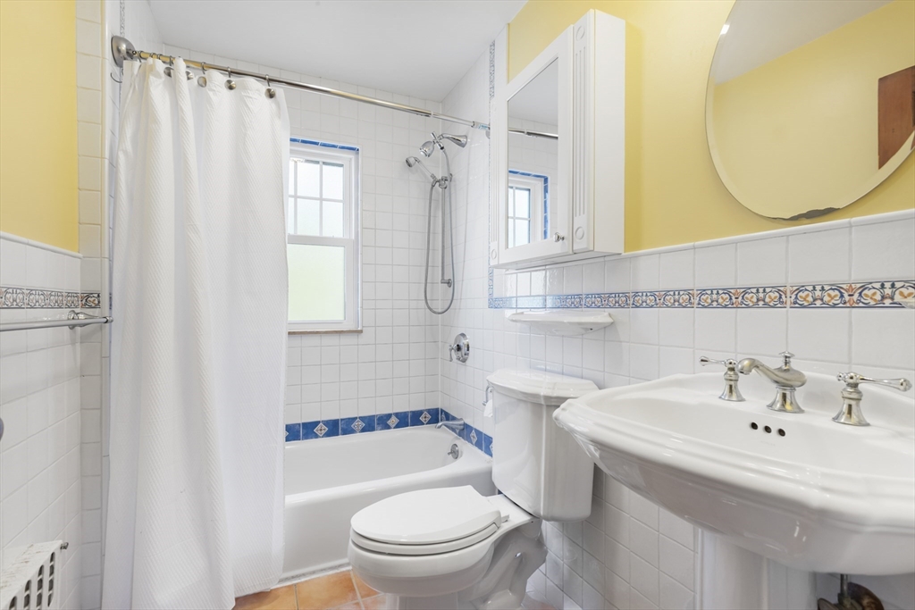 54 Oak Street Dedham, MA 02026 - Photo 22 of 36 a bathroom with a sink a toilet and a mirror
