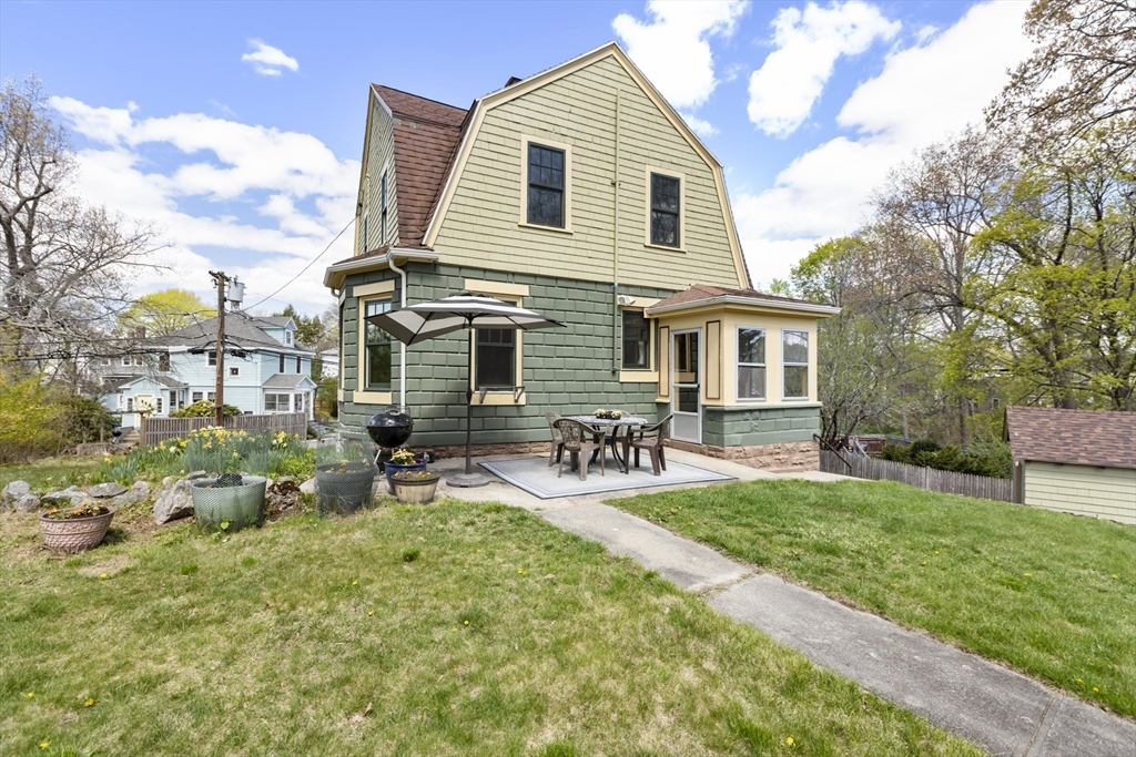 54 Oak Street Dedham, MA 02026 - Photo 27 of 36 a view of backyard of house with wooden deck and seating space