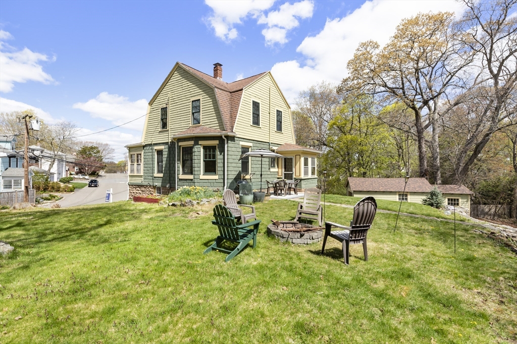 54 Oak Street Dedham, MA 02026 - Photo 28 of 36 a view of a house with a yard patio and fire pit