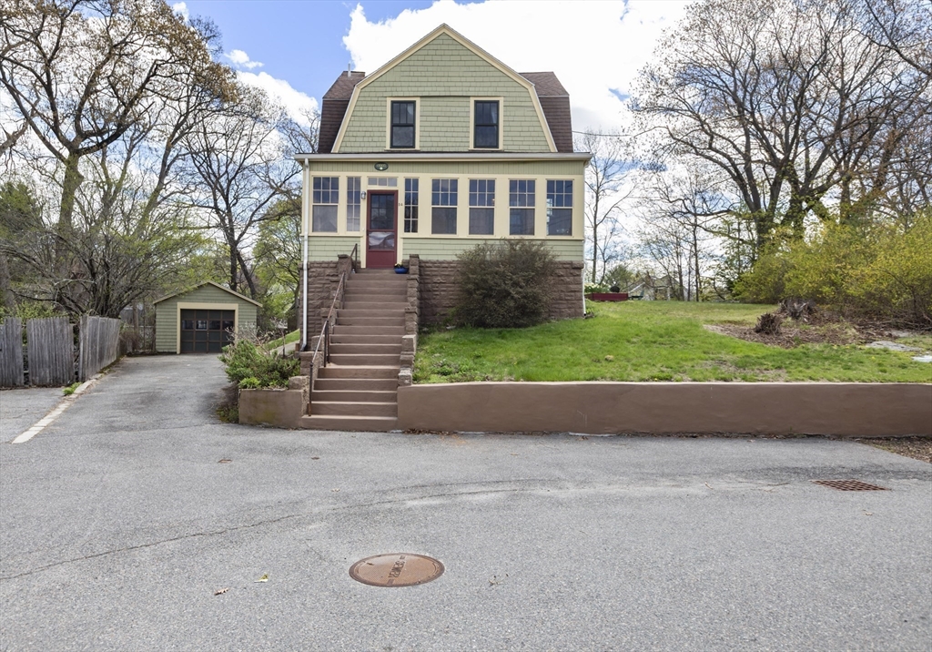 54 Oak Street Dedham, MA 02026 - Photo 3 of 36 a front view of a house with a yard and garage