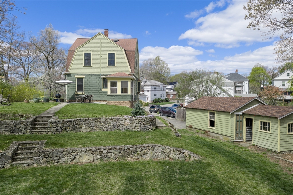 54 Oak Street Dedham, MA 02026 - Photo 36 of 36 a front view of a house with a garden