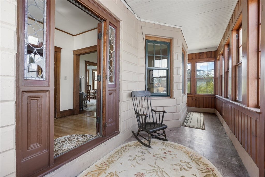 54 Oak Street Dedham, MA 02026 - Photo 4 of 36 a view of a hallway with a dining room and furniture
