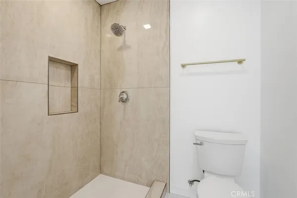 a bathroom with a shower and a toilet