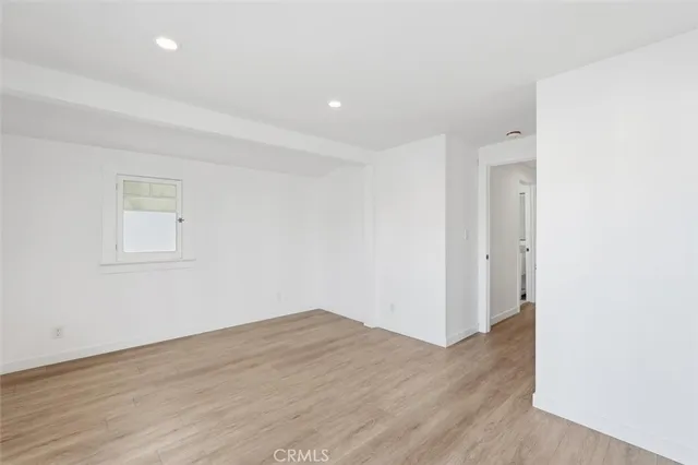 an empty room with wooden floor