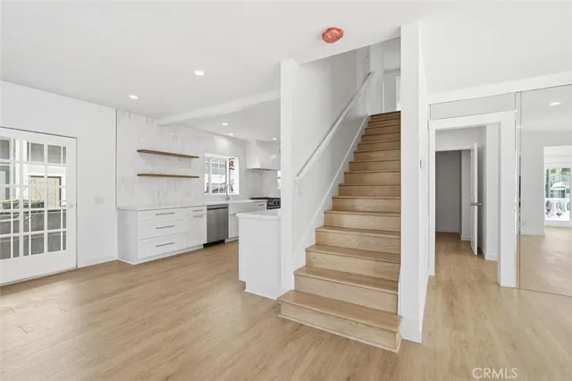 a view of a kitchen with wooden floor and stairs