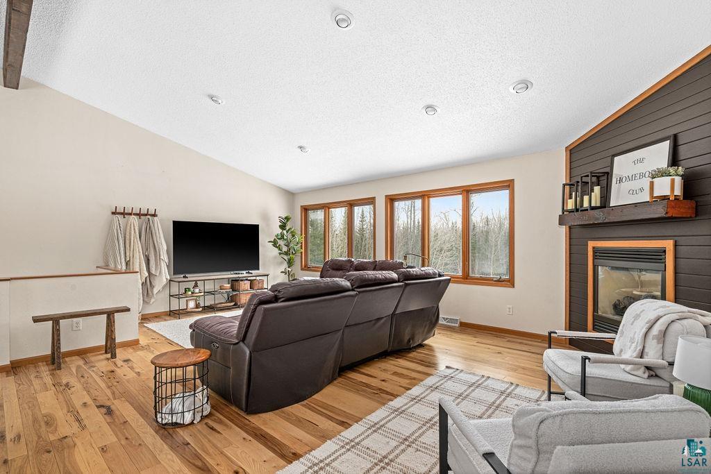 2783 Lauren Road Duluth, MN 55804 - Photo 25 of 47 Living room with light wood-style floors and a large fireplace