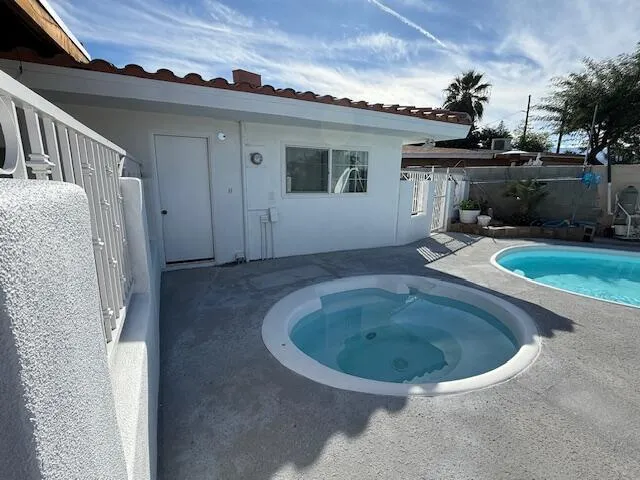 a view of a house with a tub and fire pit