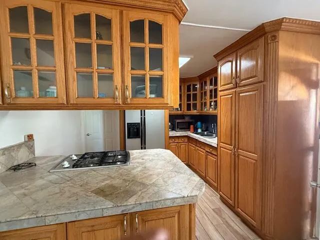 a kitchen with stainless steel appliances granite countertop a refrigerator and a stove top oven