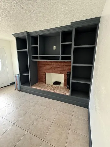 a view of an empty room with empty shelves