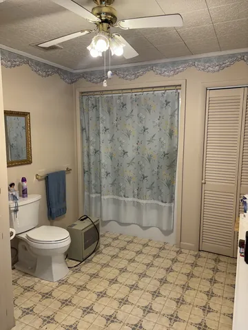 a bathroom with a toilet and a shower