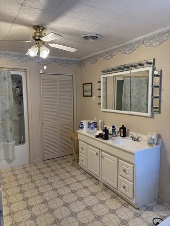 a kitchen with stainless steel appliances a stove refrigerator and cabinets