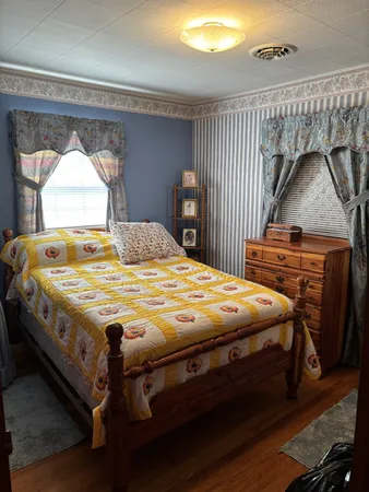 a bedroom with a bed and a window