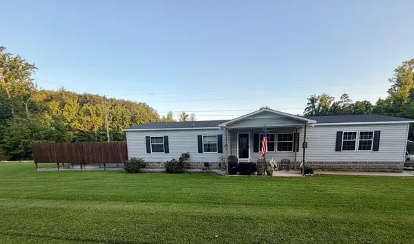 a front view of house with yard and green space