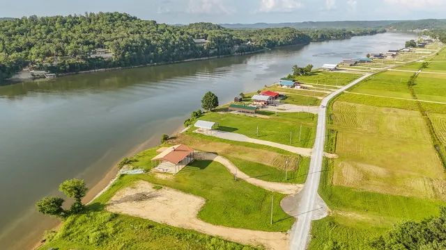 a bed sitting in a bedroom next to a yard with wooden floor